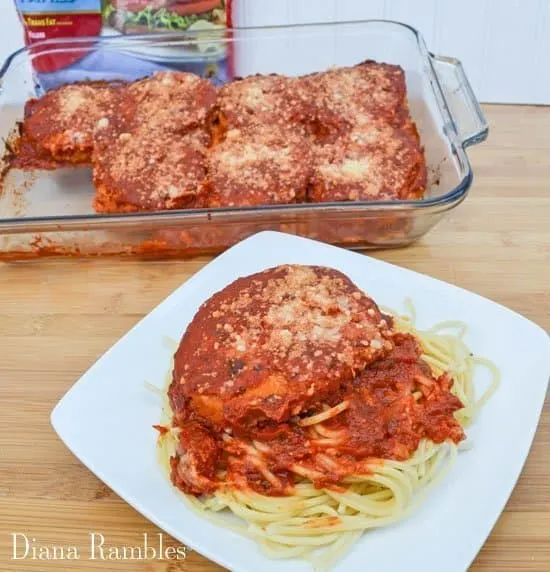plate of chicken parmesan with a casserole dish of it behind