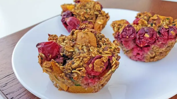 close up of 3 vegan cranberry muffins