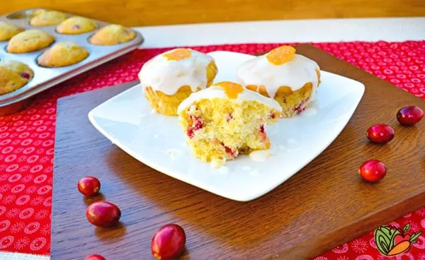 3 muffins on a white plate with a muffin tin in the background