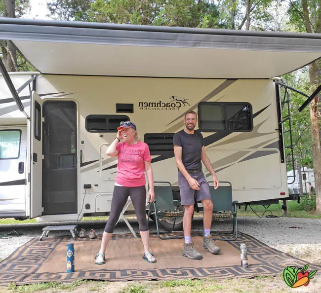couple goofing around outside of a motorhome