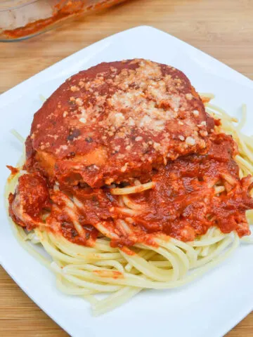 Serving of Chicken Patty Parmesan on a white plate