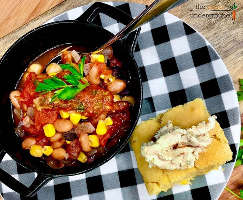 chili in a crock with corn bread on the side