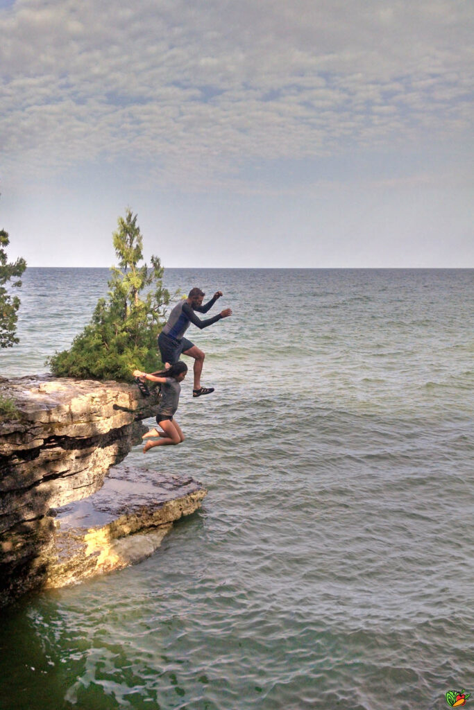 2 people Jumping off a Cliff into Lake Michigan