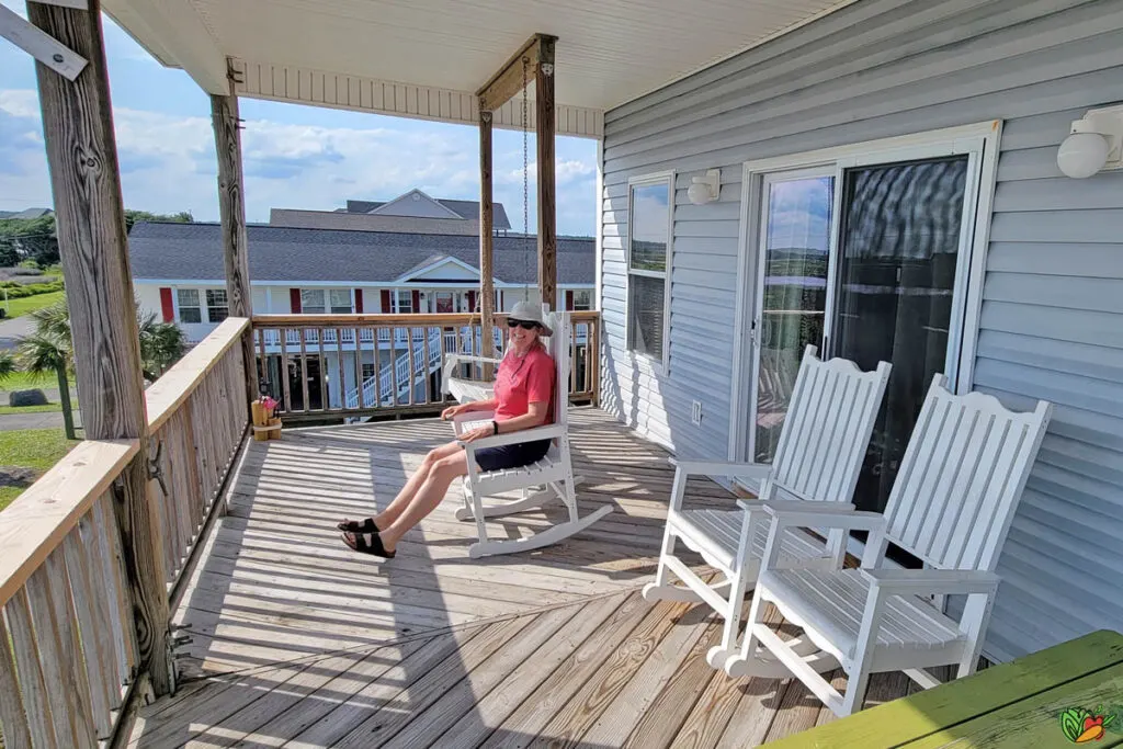 woman rocking on the Top Deck of the best surf city rental house