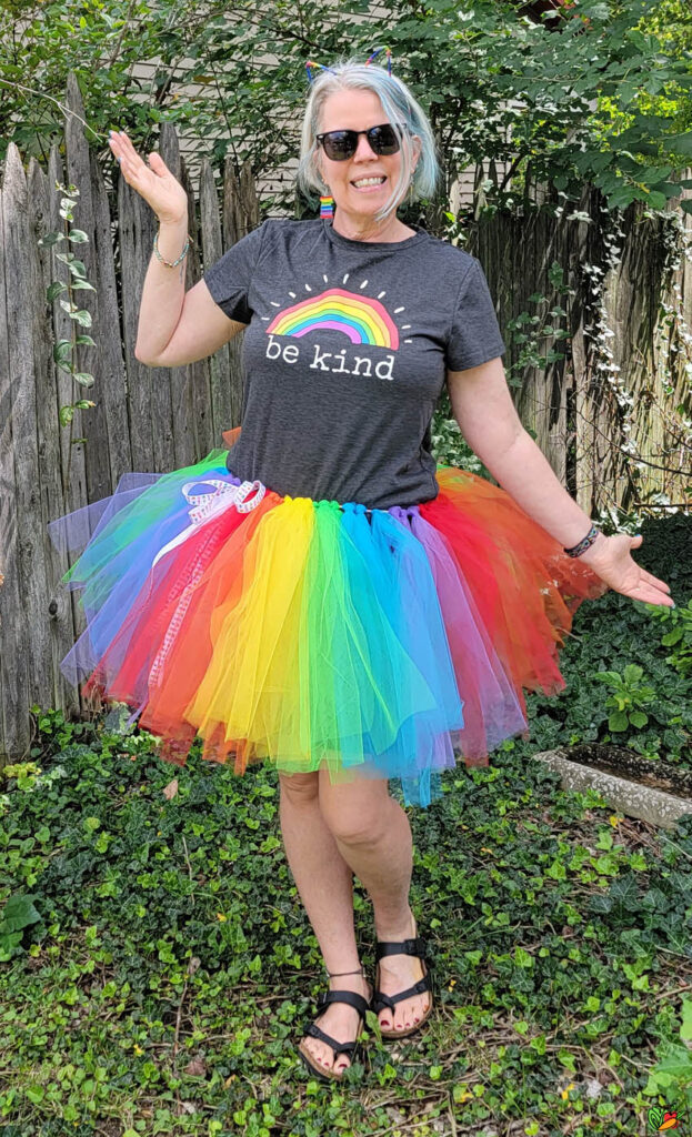 happy woman wearing a rainbow tutu
